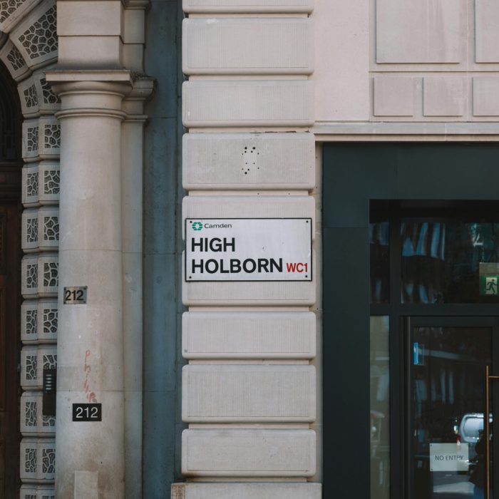 Elegant facade on High Holborn with classic architecture and street sign in Camden, London